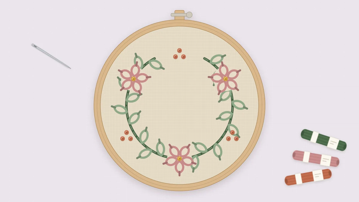 Finished embroidered wreath in a 6-inch hoop on natural linen, with a green vine and leaves, three rose flowers, terracotta berries and an empty center